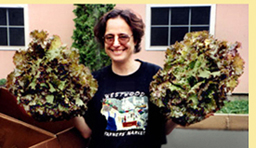 Hilary holding two heads of organic lettuce